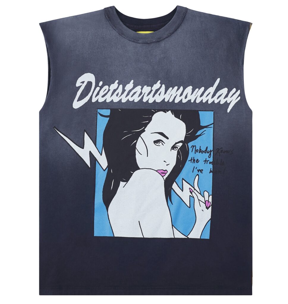 Model wearing Diet Starts Monday Trouble Sleeveless Tee in Vintage Black, styled with relaxed jeans and statement shoes